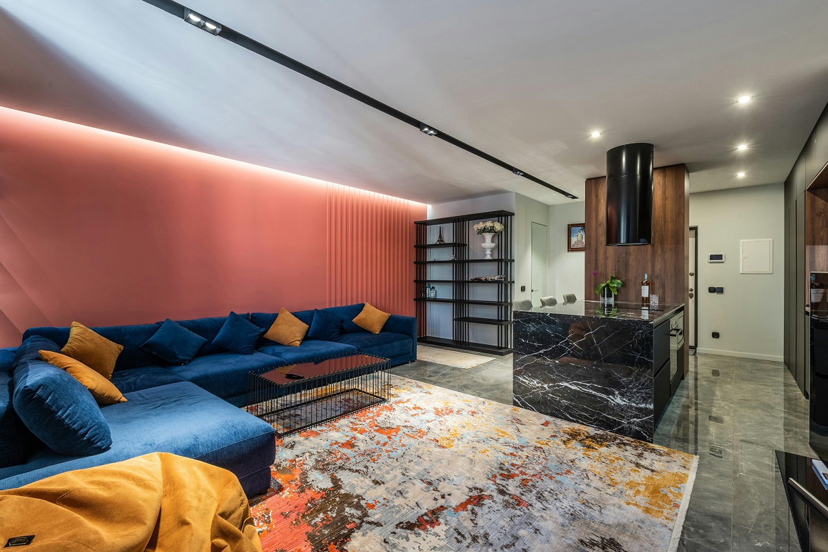 modern basement living area with orange and white walls