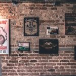 red brick basement wall with a collection of vintage metal signs